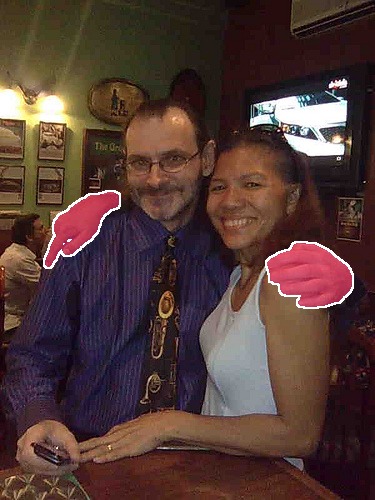 The photo with the two touching hands cut out as a segmentation mask